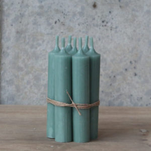Bundle of short green dinner candles tied with twine