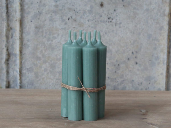 Bundle of short green dinner candles tied with twine