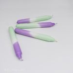 Dip dye candles in violet purple and mint green, lying on their side th