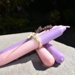 violet and pink dip dye candles with sprig of lavender tied with twine