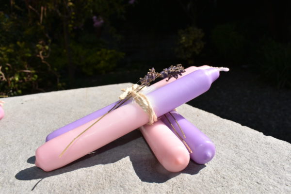 violet and pink dip dye candles with sprig of lavender tied with twine
