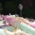 violet, mint and pink dip dye candles tied in pairs with sprigs of lavender