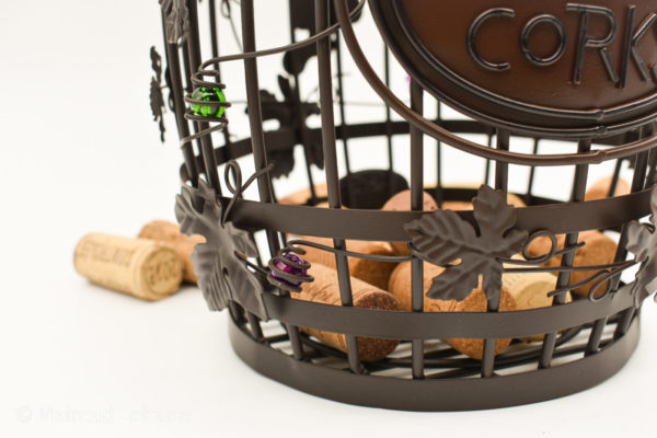 close up of wine corks at the end of barrel shaped cork cage