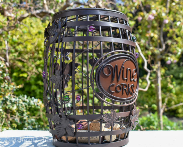 barrel shaped wine cork holder with wine corks in the garden