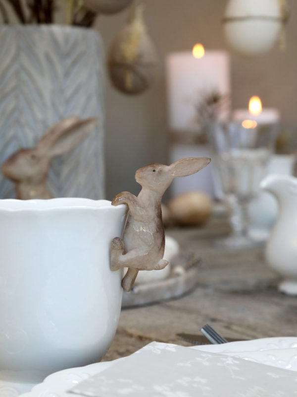 small hare hanging decoration on side of vase