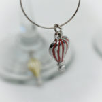 close up of red hot air balloon wine glass charm