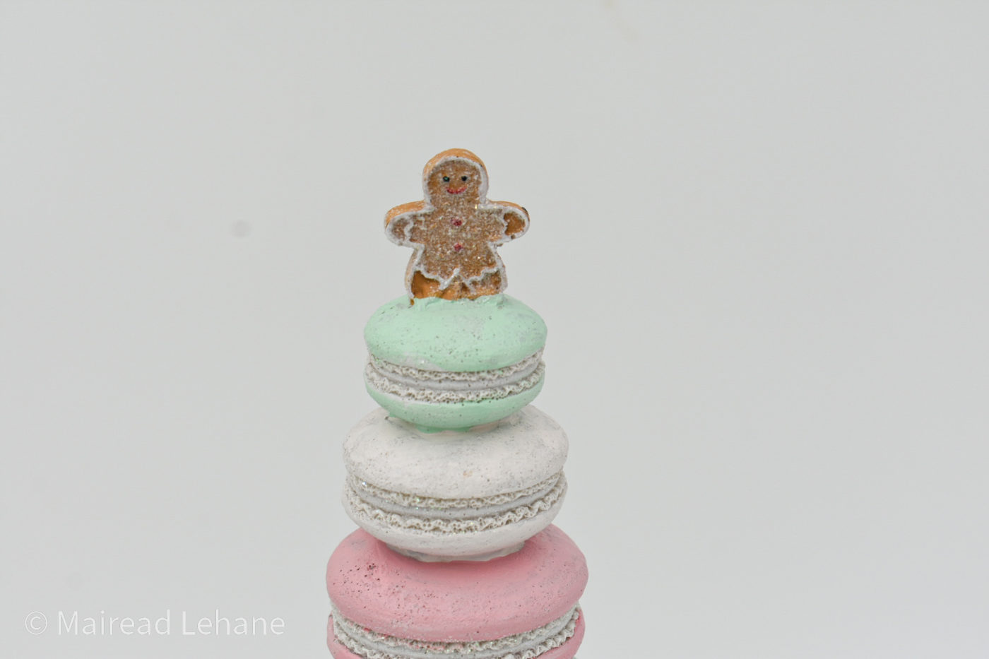 macaron cone shaped tree with gingerbread man on top