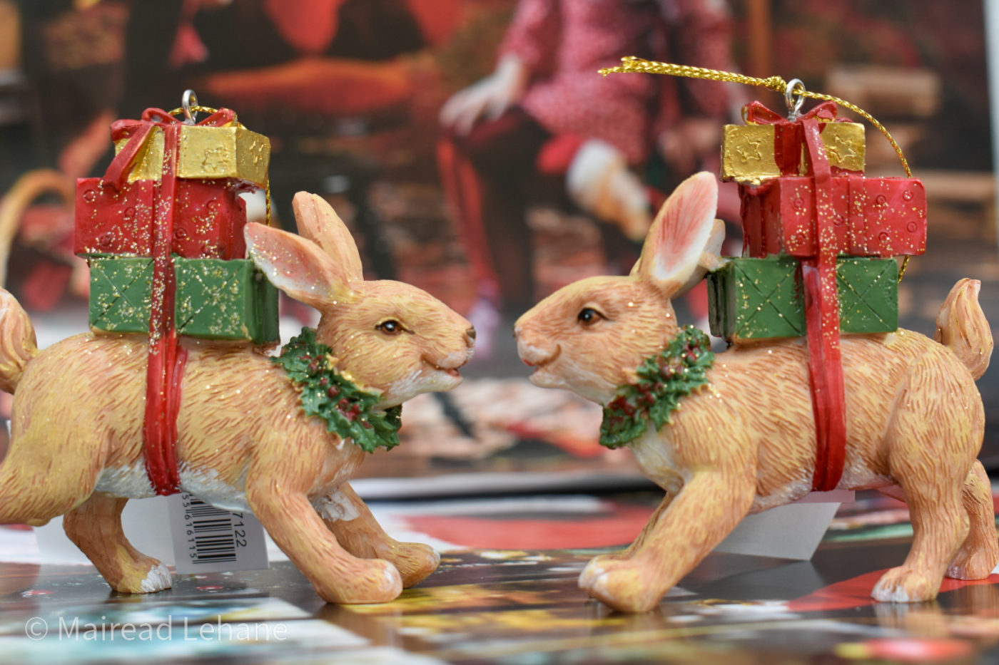 Christmas bunnies facing each other with gifts and garlands