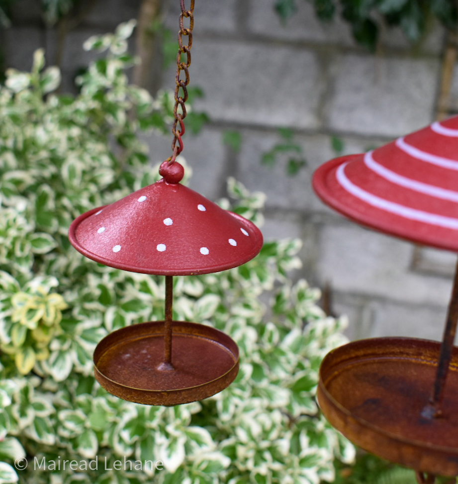 red and white mini bird houses, one red with wite dots, the other red with wite stripes
