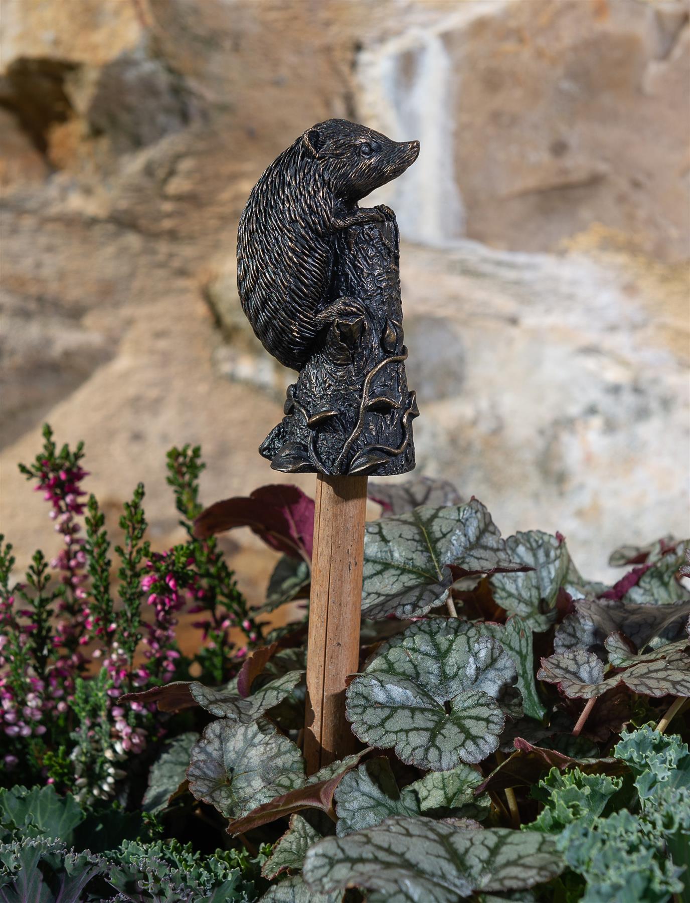 Hedgehog plant stake topper in pot with plants