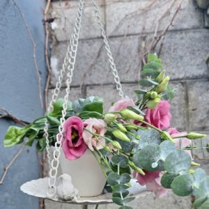 cup and saucer hanging garden decoration with bird and flower bouquet